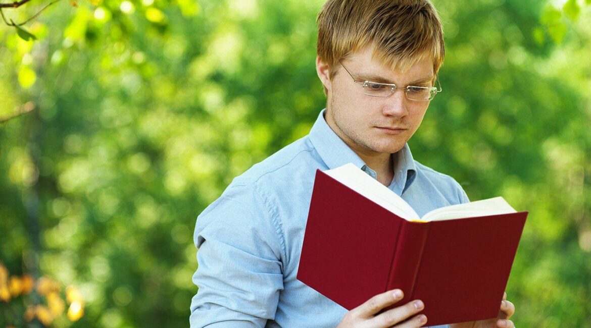Man Reading a Book Outside