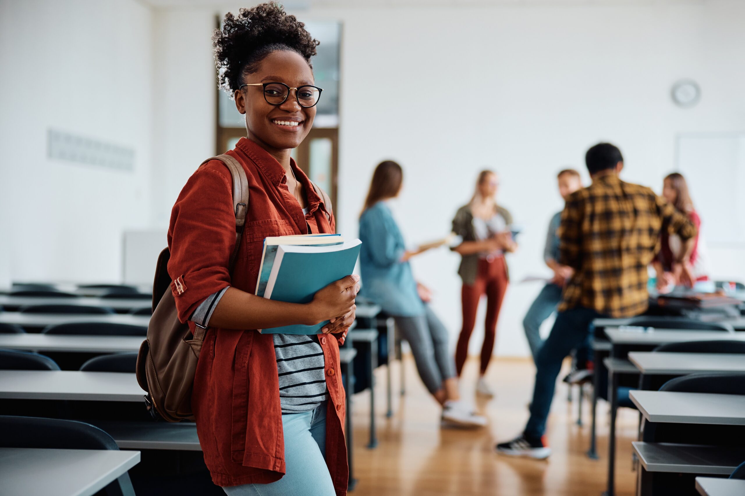 Young,Happy,Woman,At,University,Classroom,Looking,At,Camera.